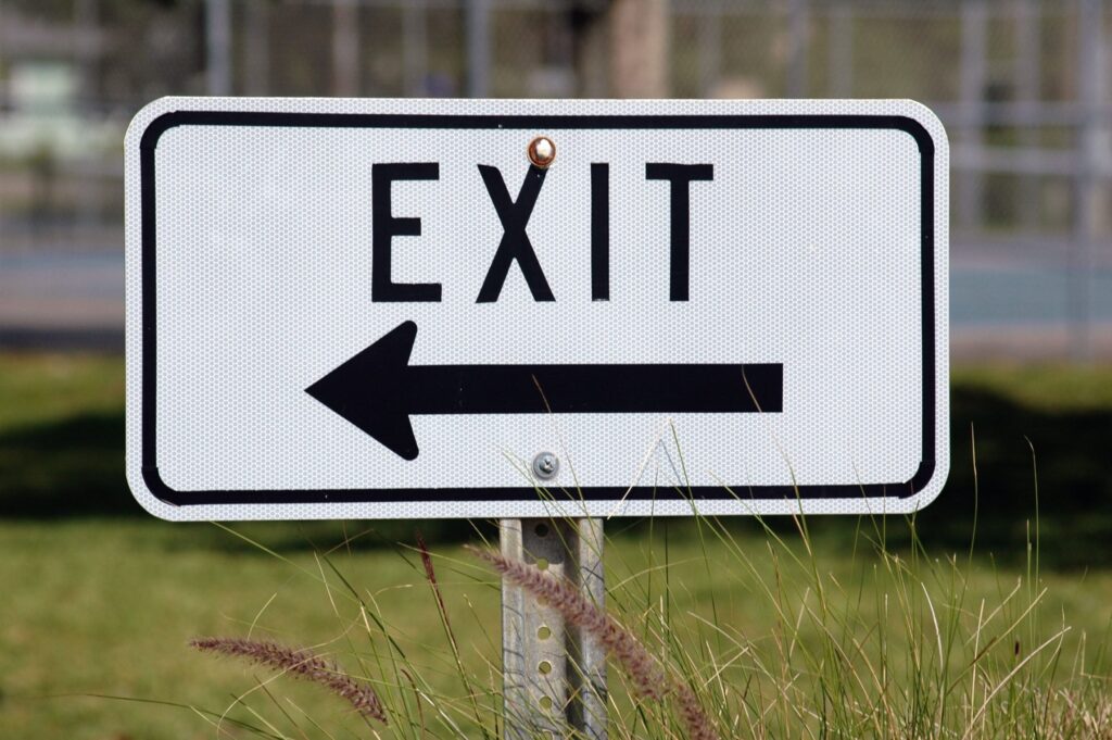 exit sign for business in grass