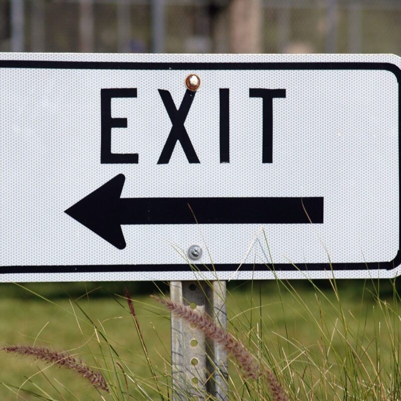 exit sign for business in grass